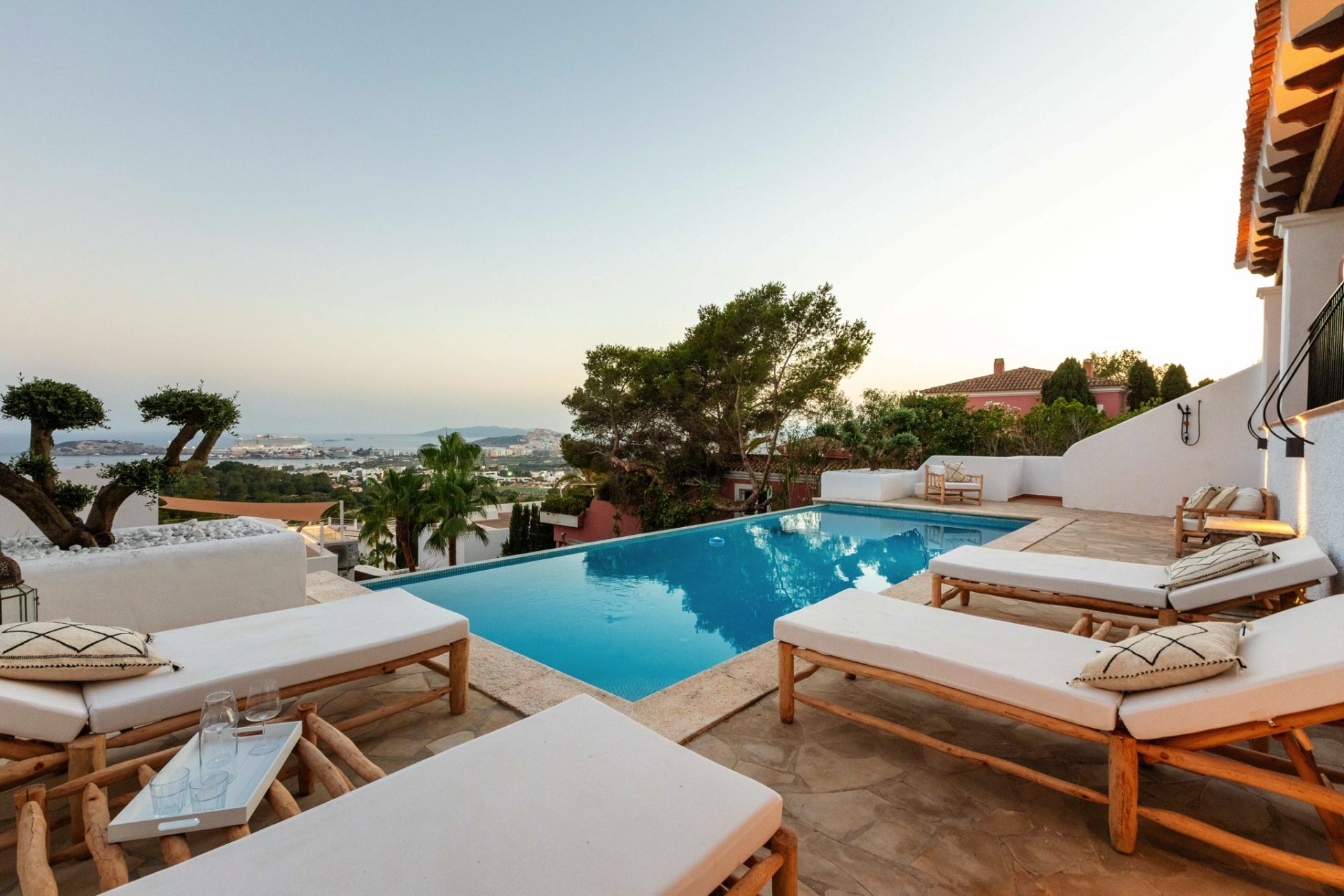 Terrace with pool overlooking the bay of Ibiza Town at sunset